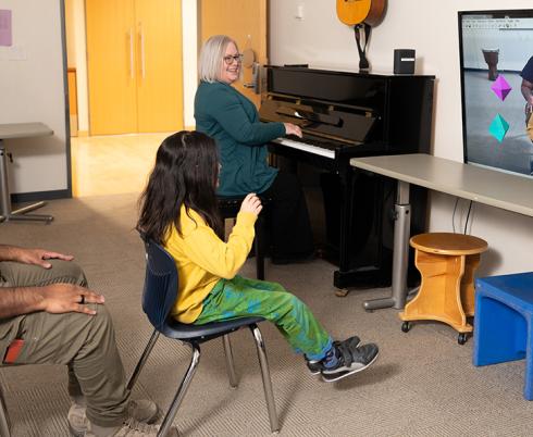 A child plays music using a virtual music instrument