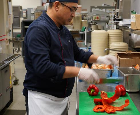 Chef is preparing some food in a kitchen