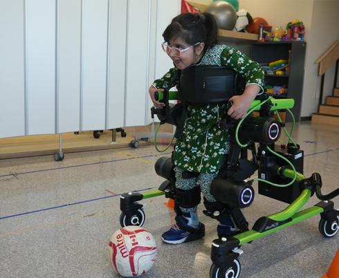 A child using the Trexo to move around a room