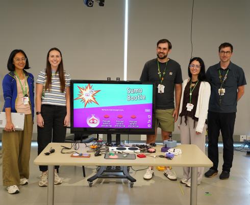 clinical team poses with adaptive gaming devices